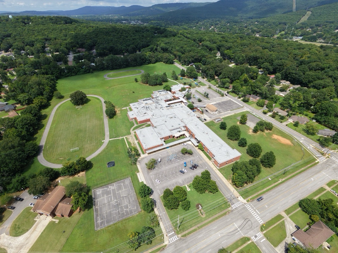 Recent aerial view of Mountain Gap School, its track and fields, surrounding neighborhoods, and Green Mountain